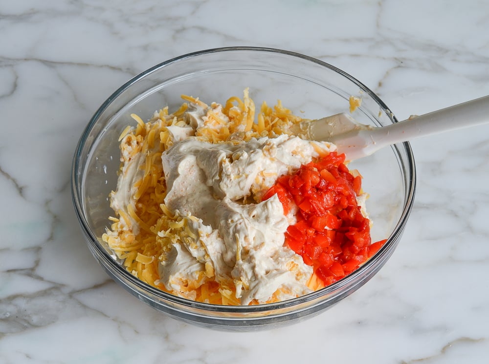 Bowl of unmixed pimento cheese ingredients.
