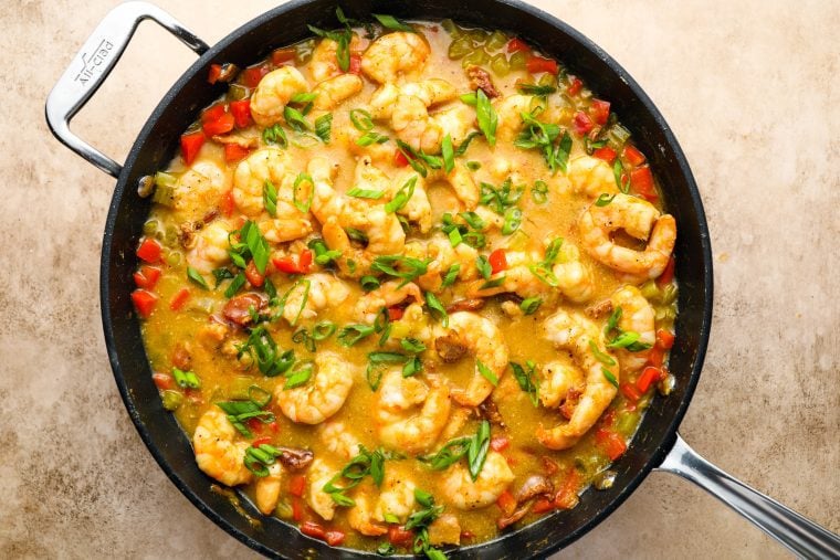 adding scallions to shrimp