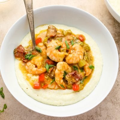 Spoon in a bowl of shrimp and grits.