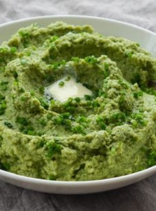 Spoon in a bowl of broccoli puree.