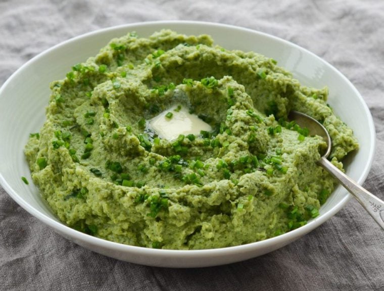 Spoon in a bowl of broccoli puree.
