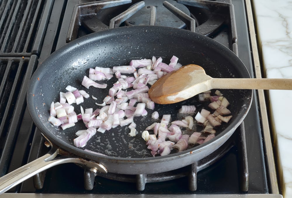 Skillet of diced shallots.