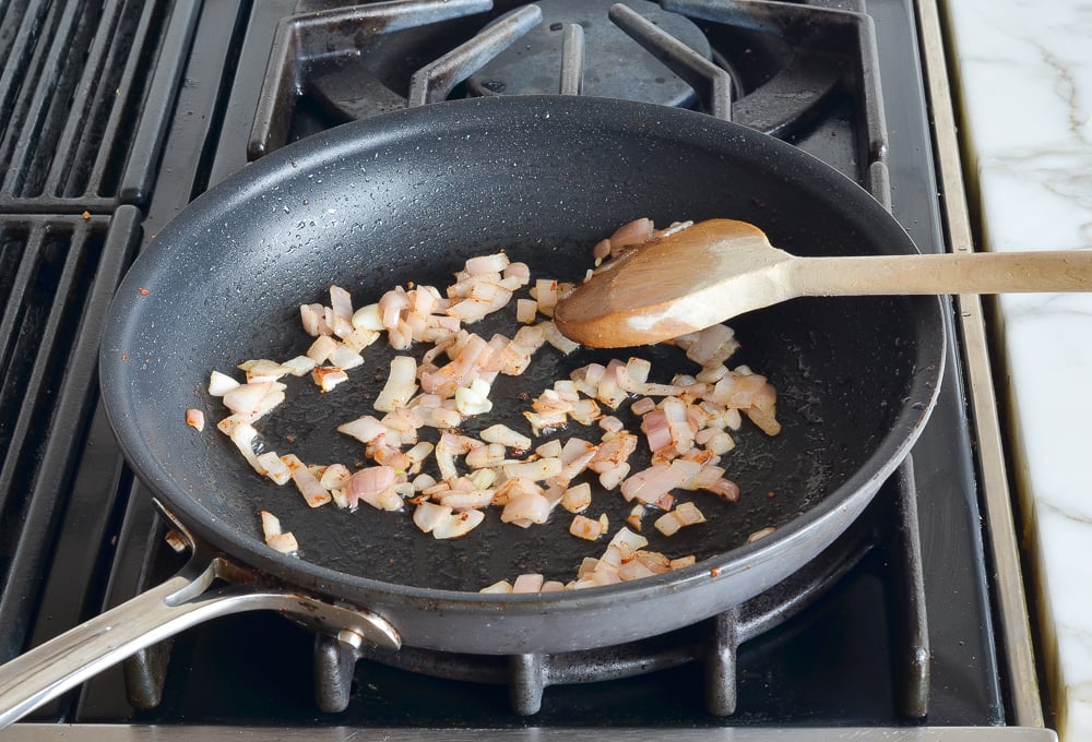 Cooked shallots in a skillet.