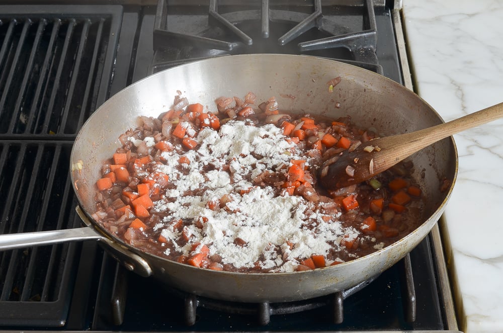 adding the flour to the skillet