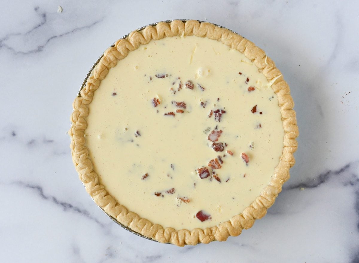 Pie crust full of and egg mixture.