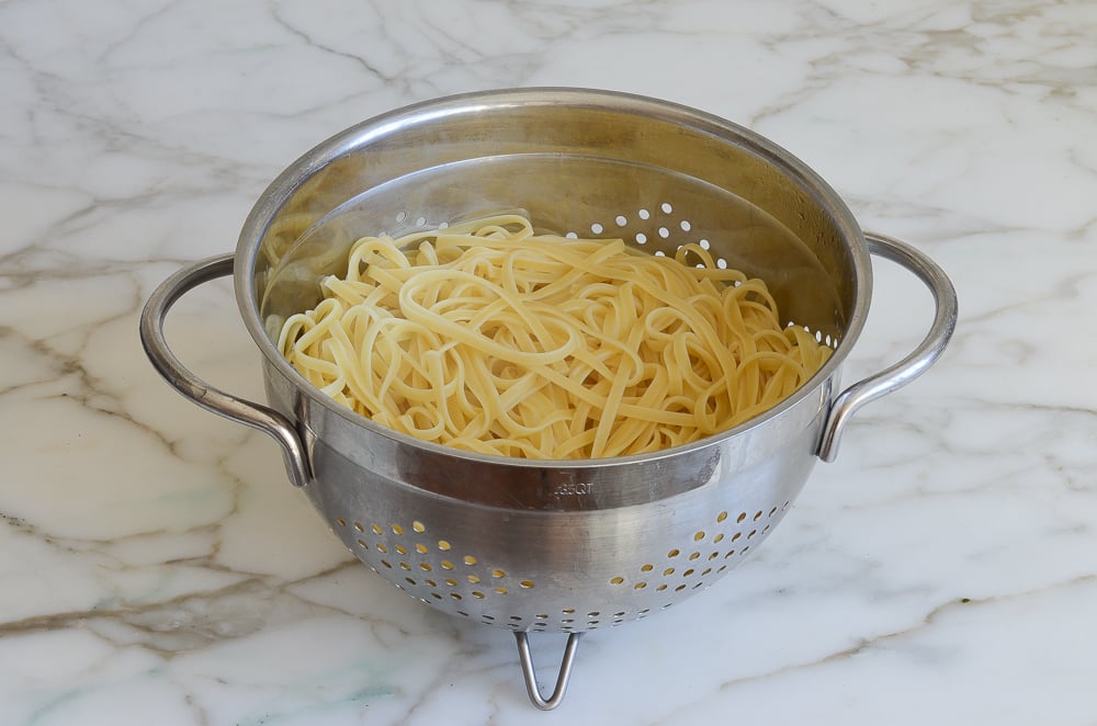 Linguine in a colander.