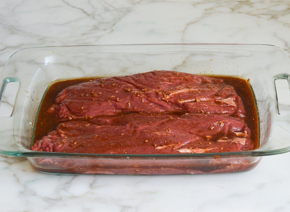 steaks marinading in dish