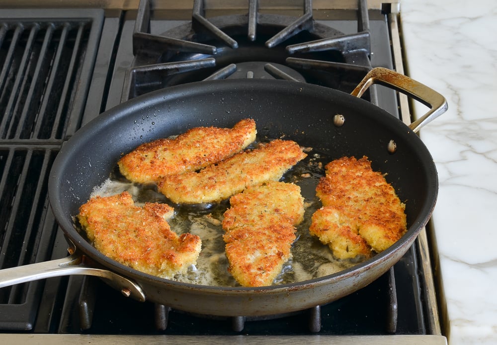 golden brown chicken in pan