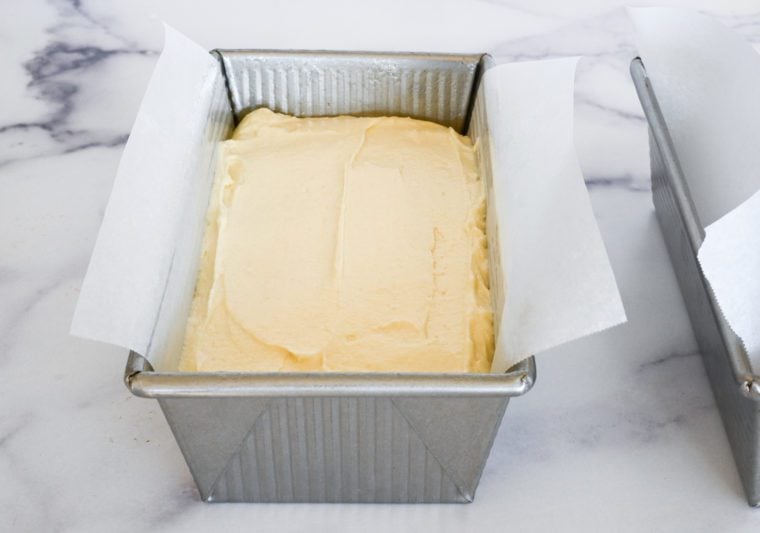 Loaf pan full of lemon pound cake batter.