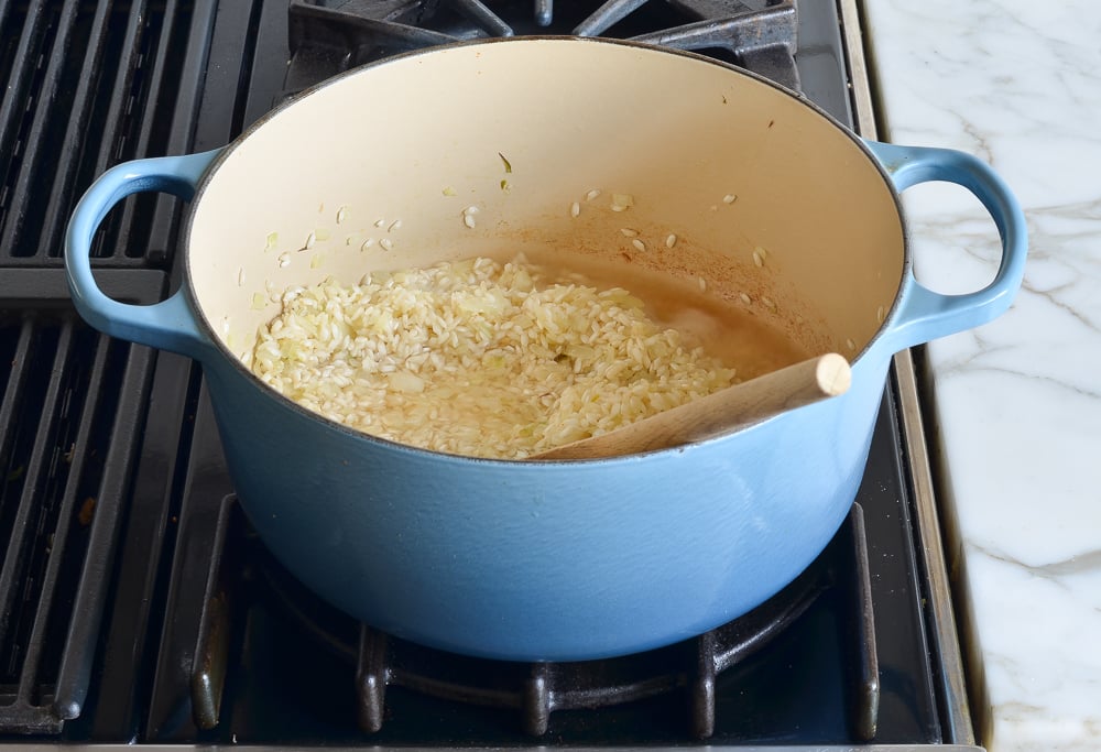 adding the wine to the rice