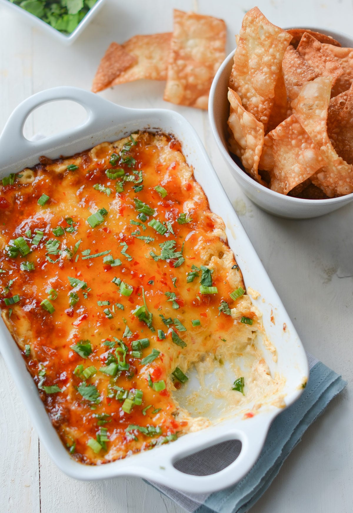 Dish of hot crab Rangoon dip with crispy wonton chips.