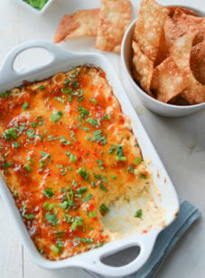 Dish of hot crab Rangoon dip with crispy wonton chips.