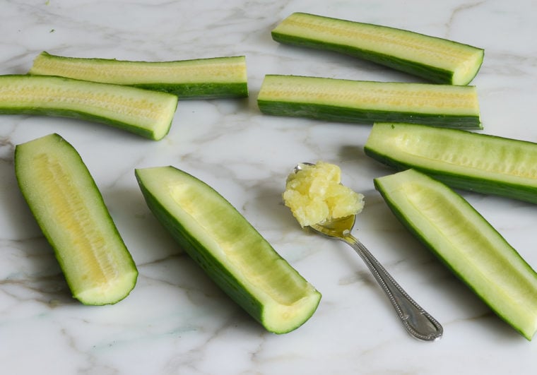 Seeded cucumbers on a marble countertop.