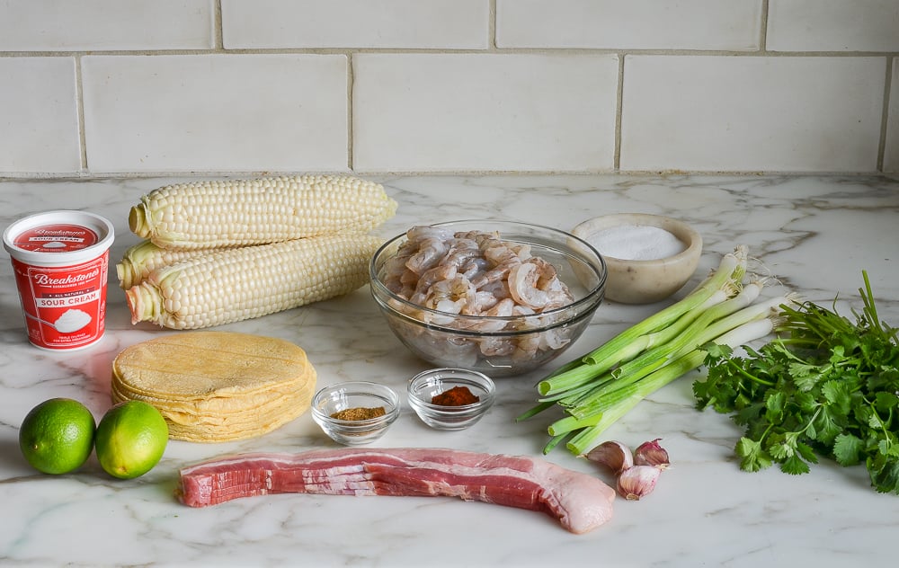 ingredients for shrimp tacos with corn, bacon and lime crema