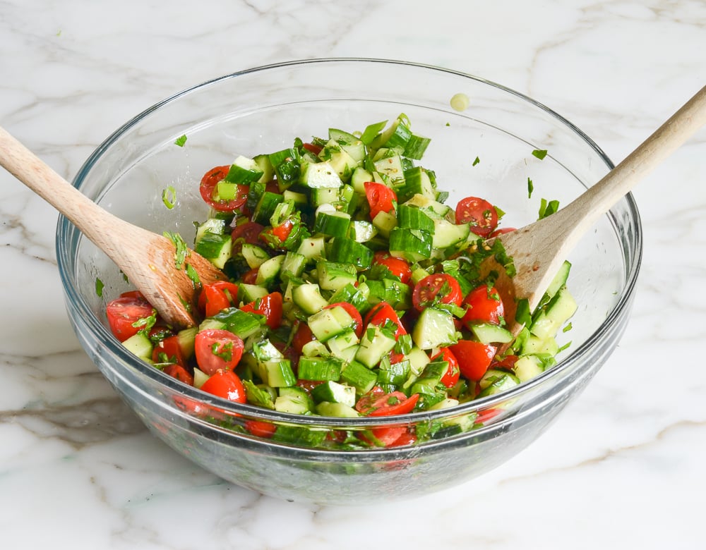tossing vegetables in mixing bowl