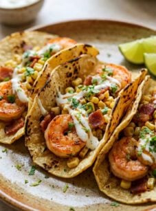 Shrimp tacos with corn, bacon, and lime crema