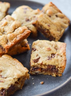 Best blondies with chocolate chips and pecans on a plate.