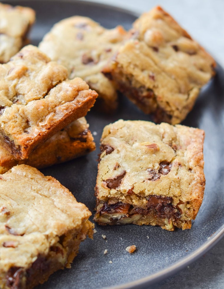 Best blondies with chocolate chips and pecans on a plate.