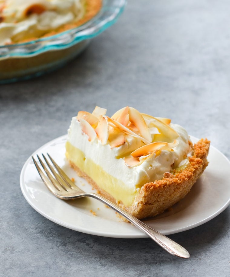 Fork on a plate with a slice of coconut cream pie.