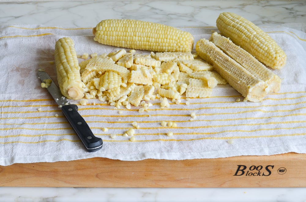 cutting corn kernels off of the cobs