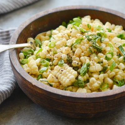 Fork in a bowl of fresh corn salad.
