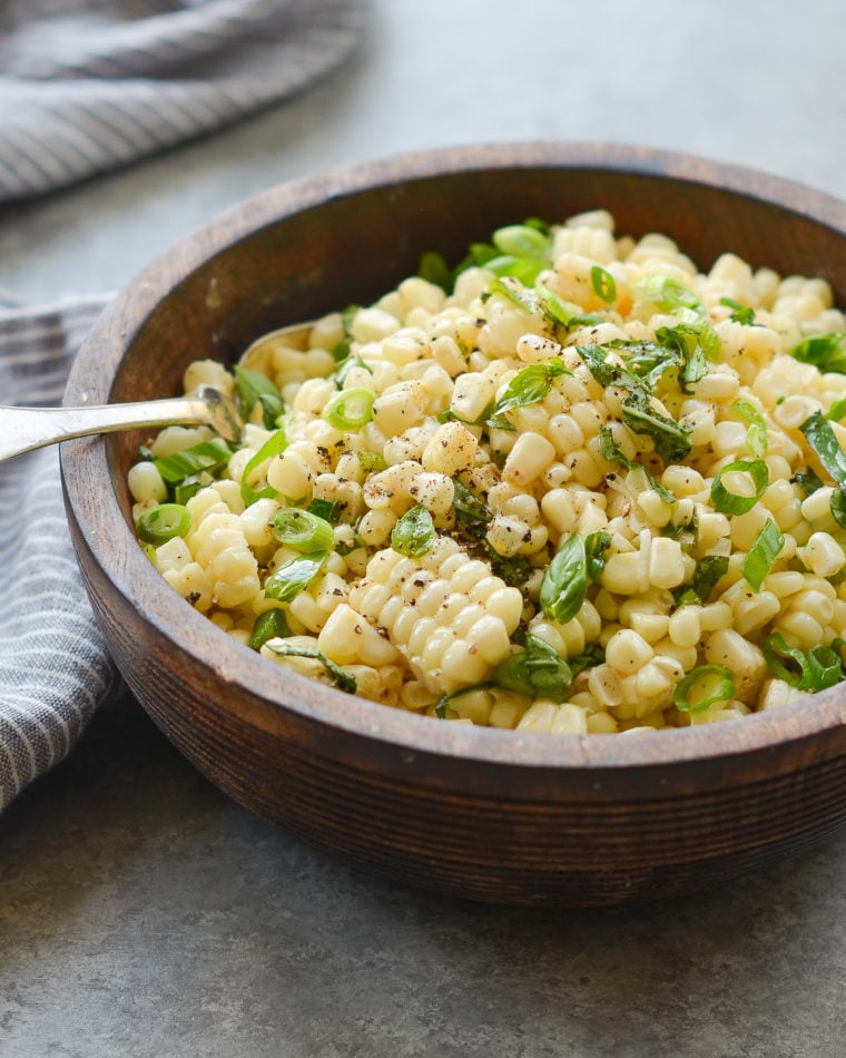 Fork in a bowl of fresh corn salad.