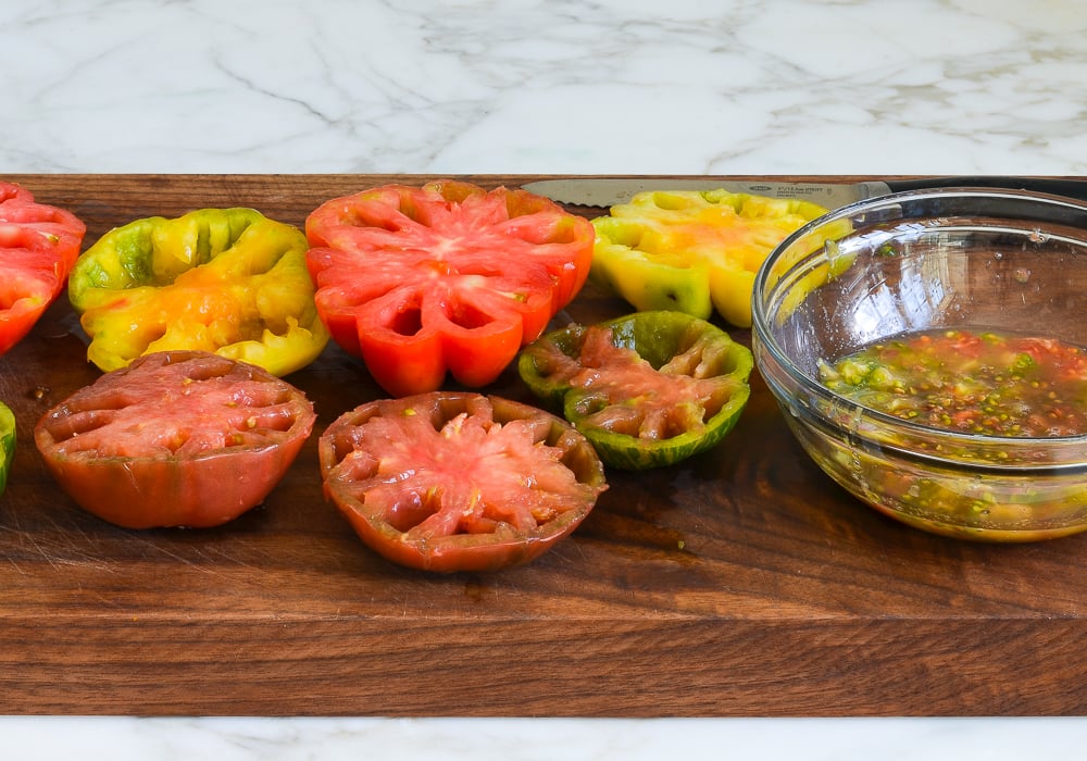 Seeded tomatoes on a cutting board.
