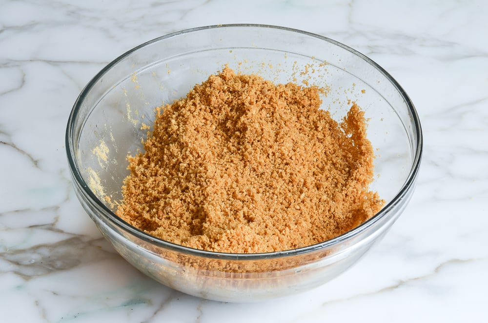 mixed graham cracker crust in mixing bowl