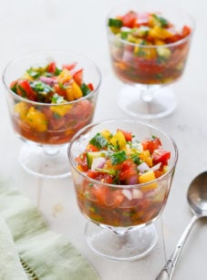 Three stemmed glasses of summer gazpacho salad.