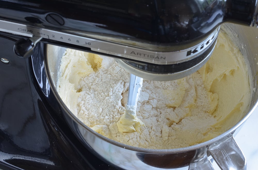adding flour to vanilla sheet cake batter