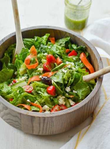 Spoons in a bowl of Italian salad.