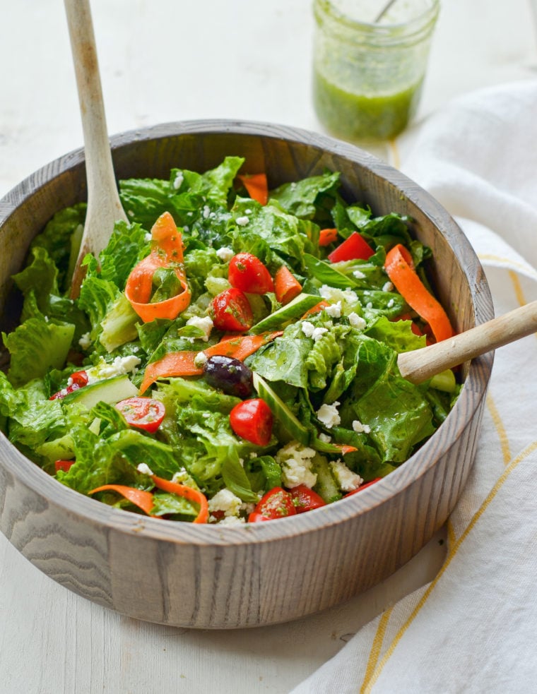 Spoons in a bowl of Italian salad.