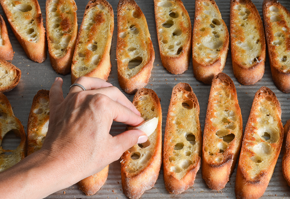 rubbing the bread with garlic