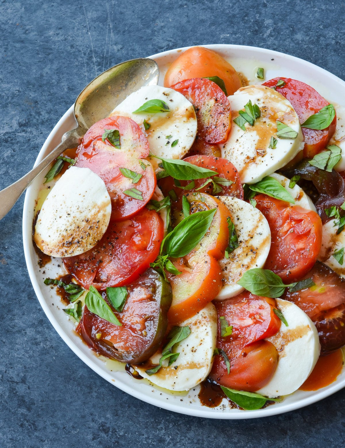Caprese salad with balsamic glaze on a plate.