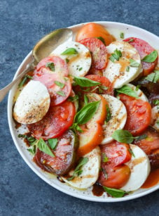 Spoon on a plate with caprese salad.