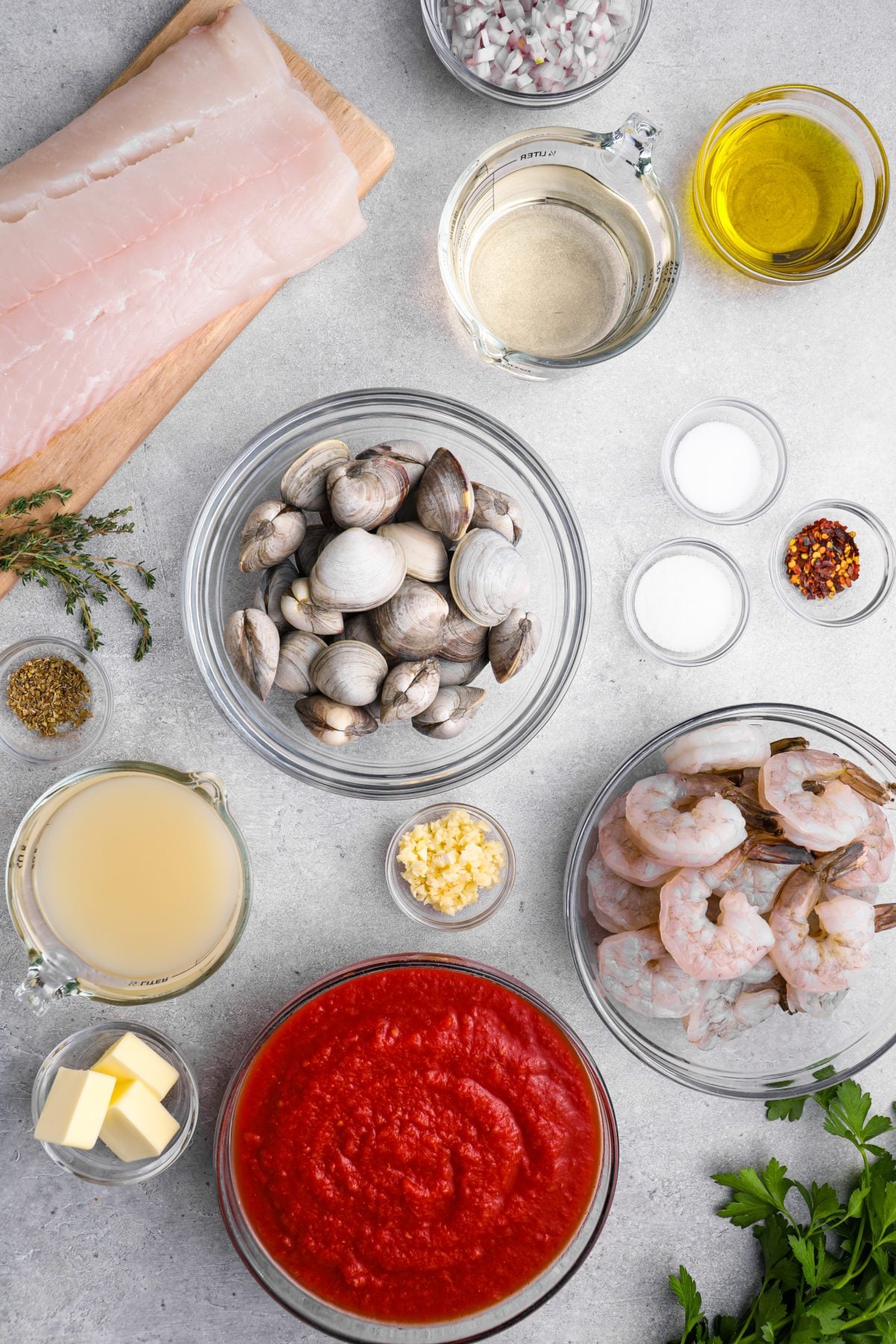 Cioppino ingredients including shrimp, butter, and crushed red pepper.