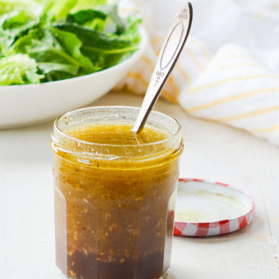 Glass jar of zesty homemade Italian dressing.
