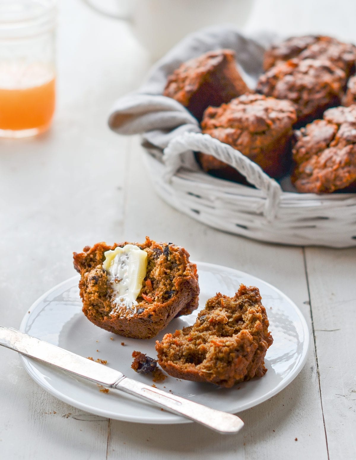 Halved morning glory muffin with butter.