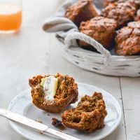 Halved morning glory muffin with butter.