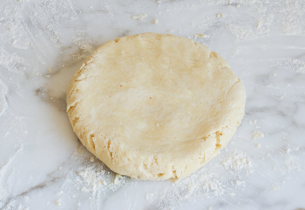 patting dough into a disc