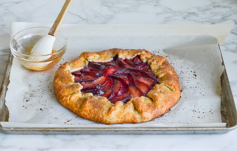 brushing apricot glaze over baked galette