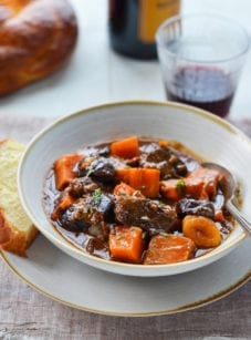 Spoon in a bowl of beef tzimmes.