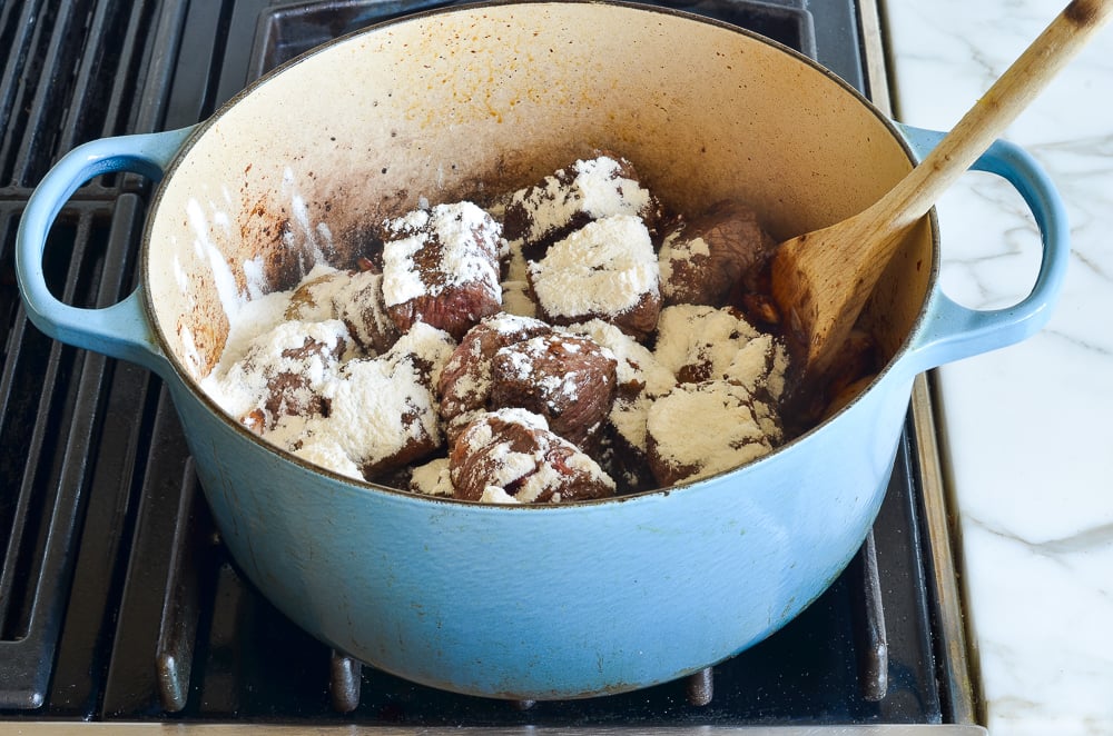 adding the meat back to the pot with the flour