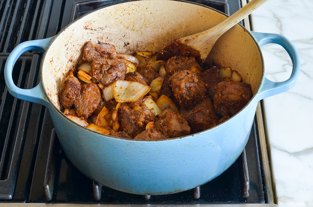 stirring the beef to dissolve the flour