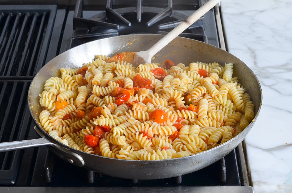 adding the pasta to the sauce