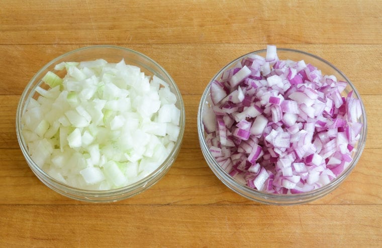 Bowls of diced red and white onions.