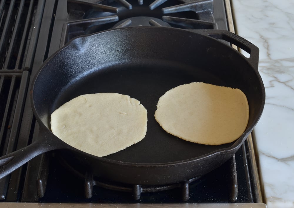 corn tortillas in skillet.