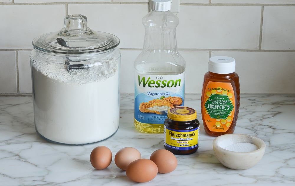 Challah ingredients including yeast, eggs, and honey.