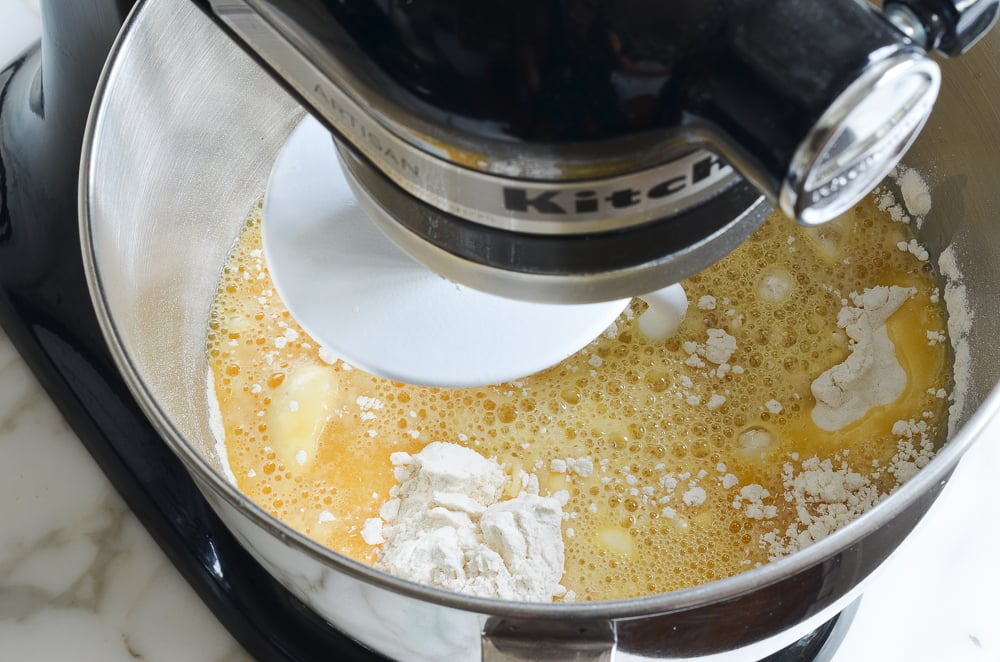 adding liquid ingredients to dry ingredients in mixer