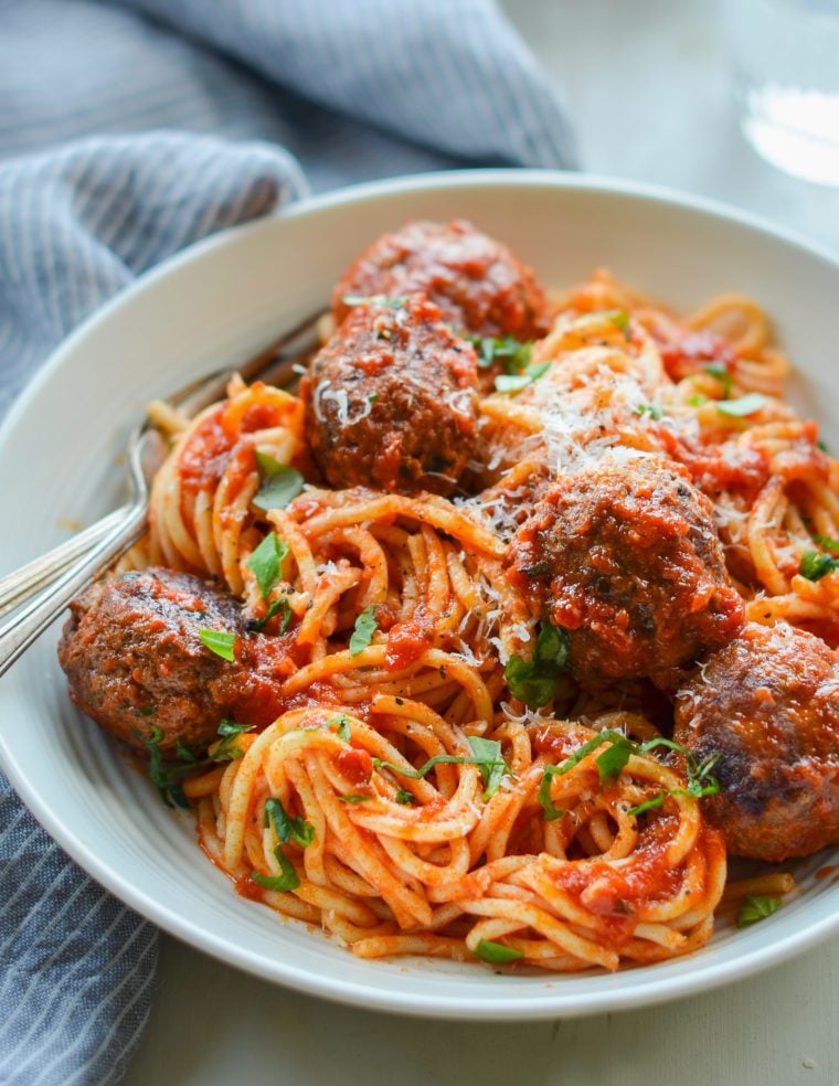 Fork in a bowl of spaghetti and meatballs.